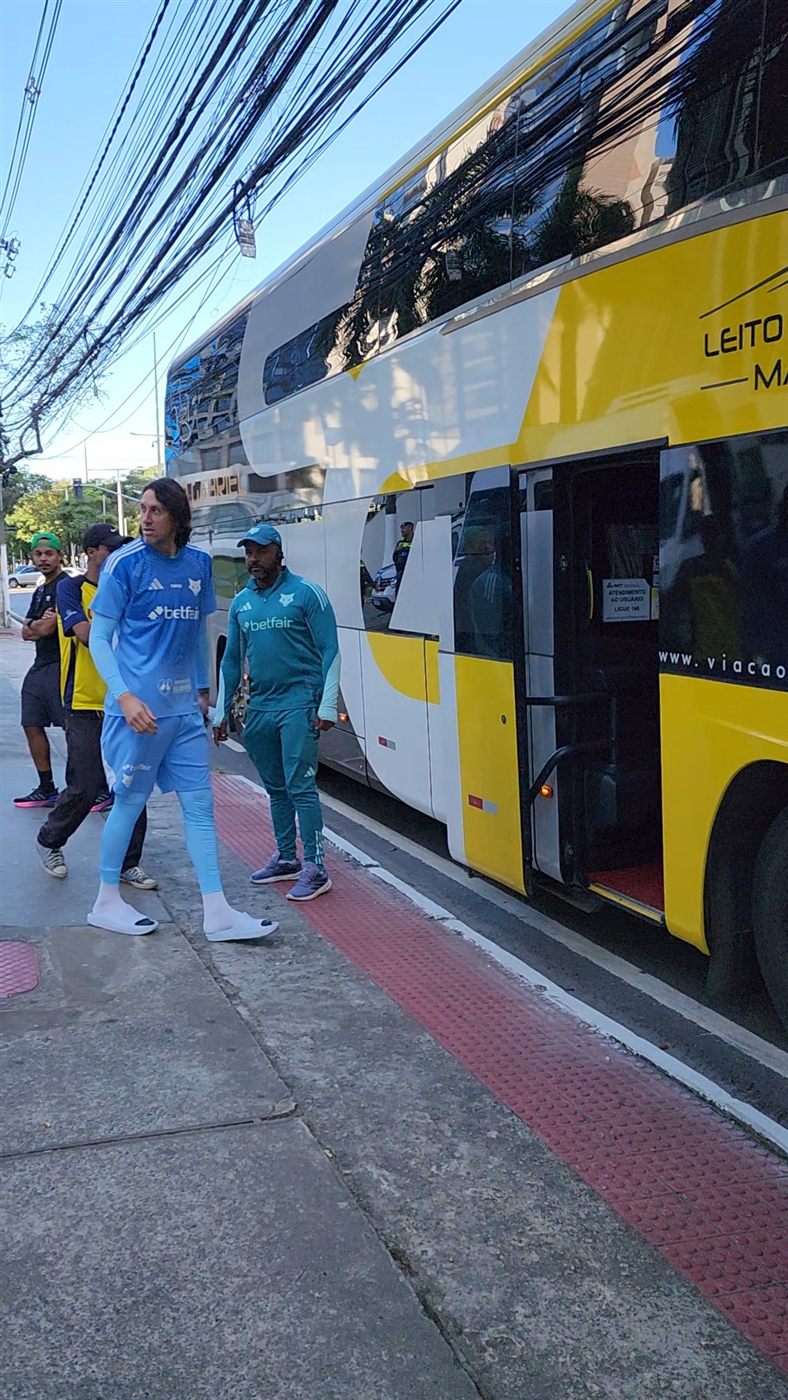 Desembarque de equipe esportiva ao lado de ônibus leito da Movix